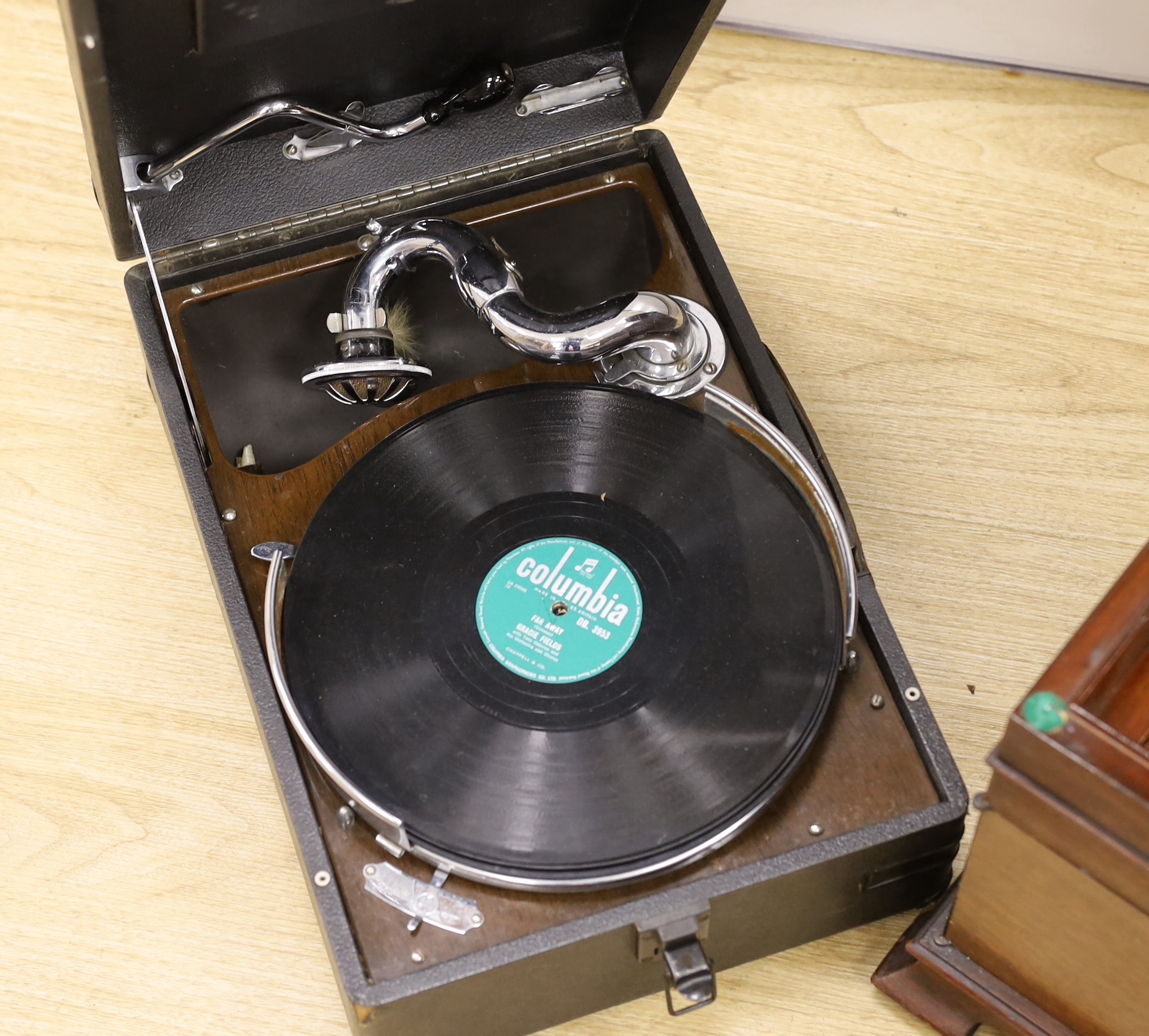 An HMV gramophone and a portable HMV gramophone, together with a small number of 78s